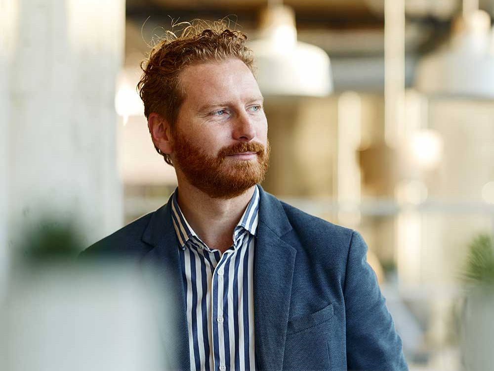 A photo of a man with red hair and a beard